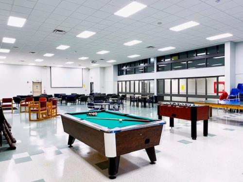 a large room with a pool table in it at Residence & Conference Centre - Sarnia in Sarnia