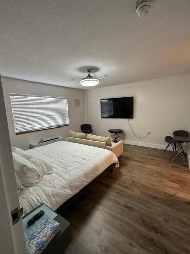 a bedroom with a bed and a flat screen tv at Beautiful renovated Studio Apartment in Gadsden AL in Gadsden