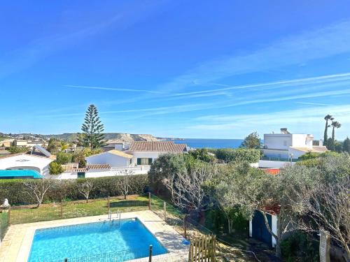 a villa with a swimming pool and a view of the ocean at Private Villa Rego with Oceanview and Pool in Luz