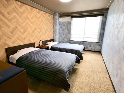 Tempat tidur dalam kamar di Apprising hotels GranJam Tsugaike - Vacation STAY 77378v