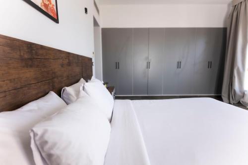 two beds with white pillows in a bedroom at El Gouna Elite Worldwide Sea & Garden Residences - Hurghada, Egypt in Hurghada