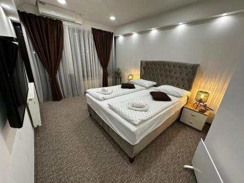 a bedroom with a large bed in a room at Pansion River in Sarajevo
