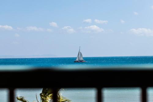 a sailboat in the ocean with a view from a window at El Gouna Elite Worldwide Sea & Garden Residences - Hurghada, Egypt in Hurghada