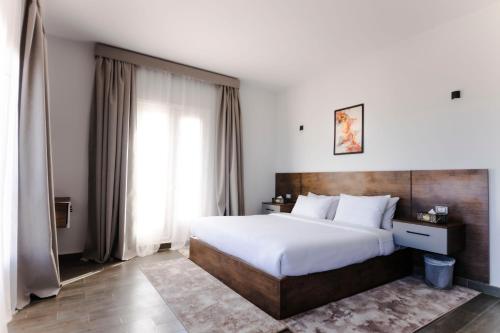 a bedroom with a large bed and a large window at El Gouna Elite Worldwide Sea & Garden Residences - Hurghada, Egypt in Hurghada