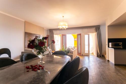 a dining room with a table with flowers on it at El Gouna Elite Worldwide Sea & Garden Residences - Hurghada, Egypt in Hurghada