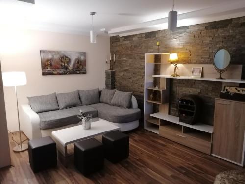 a living room with a couch and a table at Apartman Dionis SM in Sremska Mitrovica