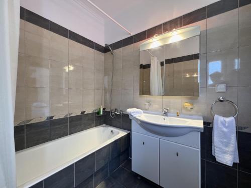 y baño con bañera, lavabo y bañera tubermottermott. en Villa Korfos, en Skala