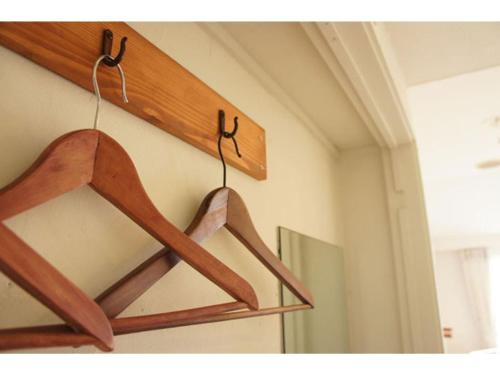a pair of wooden hangers hanging from a wall at Garden Villa Shirahama - Vacation STAY 59290v in Shimoda