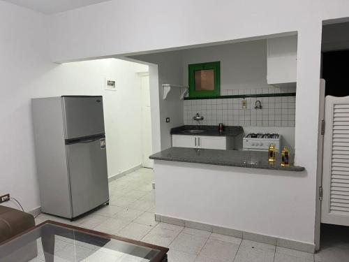 a kitchen with a refrigerator and a counter top at Apartment in the City Center Neama Bay and free Wi-Fi in Sharm El Sheikh