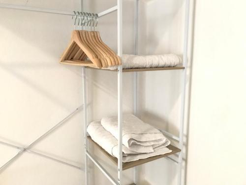 a glass shelf with towels on it in a bathroom at El rincón de Manolita #3 in Bornos