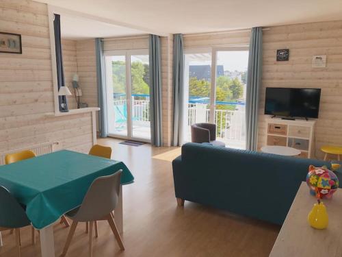 un salon avec un canapé bleu et une table dans l'établissement Bel appartement 60m2 vue mer La Baule Escoublac, à La Baule