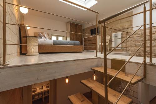 a bedroom with a bed and stairs in a room at Le Nicchie luxury rooms in Lecce
