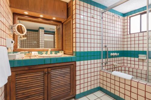 a bathroom with a sink and a mirror at Solmar Resort in Cabo San Lucas