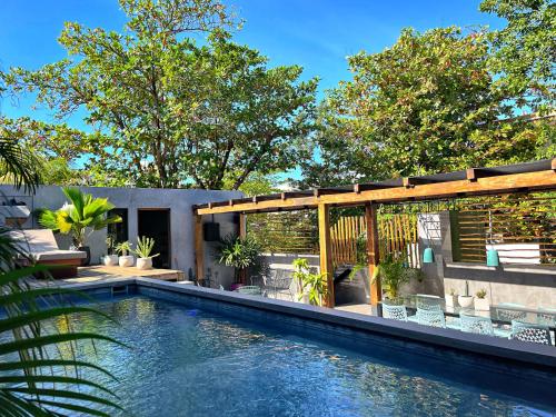 a swimming pool in a backyard with a house at LOTE4 - LGBTQ Studios in Playa del Carmen