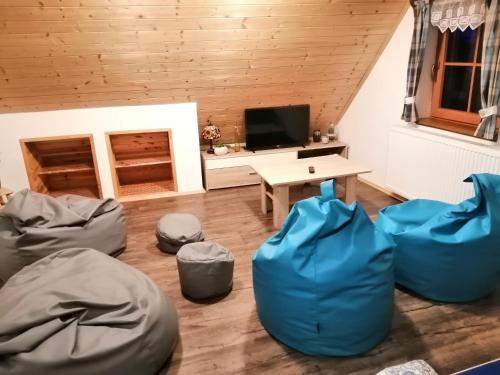 a living room with blue bean bags and a table at Apartmán Dvě Micky in Pec pod Sněžkou