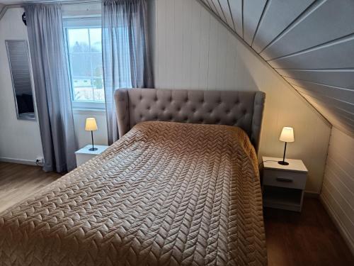 a bedroom with a large bed with a large window at Reinebu in Ørsta