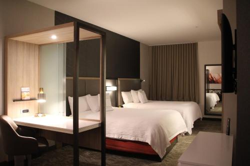a hotel room with two beds and a mirror at Springhill Suites Baltimore White Marsh/Middle River in Middle River