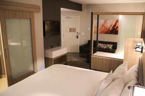 a bedroom with a bed and a living room at Springhill Suites Baltimore White Marsh/Middle River in Middle River