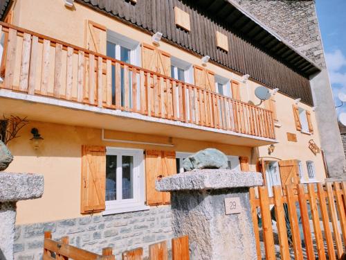 a building with a balcony and a statue in front of it at Gite Notre Désir in Abriès