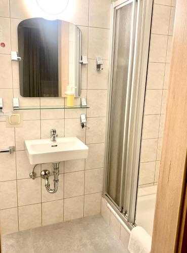 a bathroom with a sink and a shower at Gasthof 'Zum alten Turm' in Haslach an der Mühl
