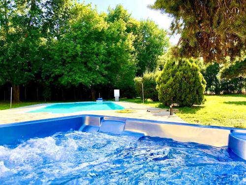 a large swimming pool with water in it at Dormi nella SPA privata con letto ad acqua, sauna, doccia emozionale e kneipp in Alessandria