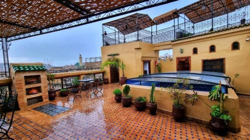 a house with a swimming pool on a balcony at Dar La Bague de Kenza in Fès