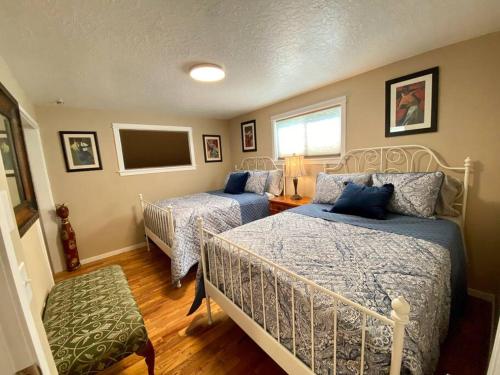a bedroom with two beds and a flat screen tv at Centrally Located Redmond Retreat with Pool Table in Redmond