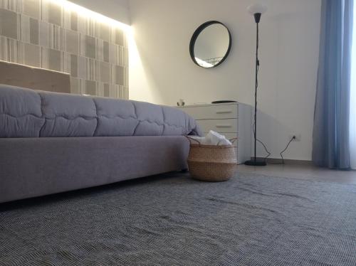 a living room with a couch and a mirror at Nonna Sicula in Agrigento