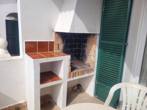 a kitchen with a brick oven in a room at Apartamento 42 en Son Parc. Playa y golf in Son Parc