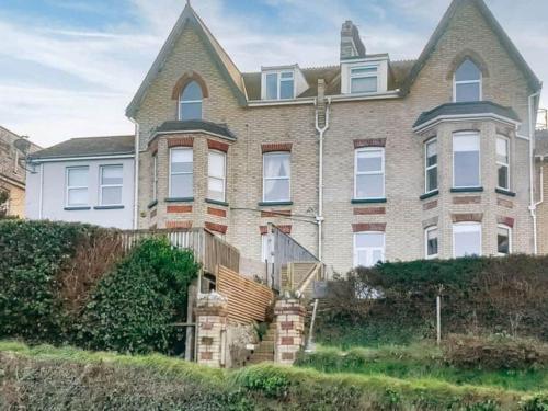 a large brick house with a roof at Chambercombe Villa - Harbour View, Decking, Garden, Games Room, sleeps 20 in Ilfracombe