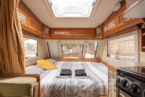 a bed in the middle of an rv at Villaverde Glamping in Villaverde