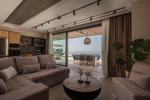 a living room with a couch and a table at Limnionas Serenity Cave Villa in Kampíon