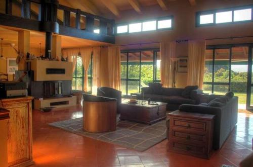 a large living room with couches and a table at Villa Boa Vista in Madalena