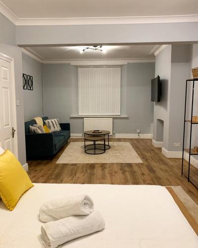 a living room with a bed and a couch at Cardiff Home in Cardiff