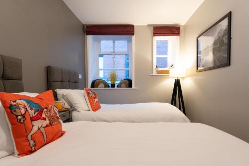 a bedroom with two beds and a window at High Street Town House in Manchester