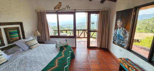 a bedroom with a bed in a room with a view at Akawanka Lodge in San Agustín