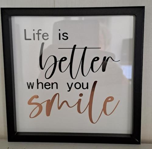 a framed sign that reads life is better when you smile at Cummins Cottage in Broken Hill
