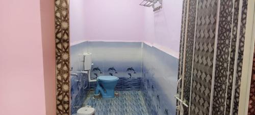 a bathroom with a blue toilet in a room at Govind Niwas Homestay in Jagdalpur