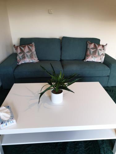 a living room with a couch and a white coffee table at Shelly's Place in Glasgow