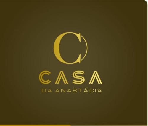 a gold logo with the letter c on a black background at O Beiral da Anastácia in Marco de Canaveses