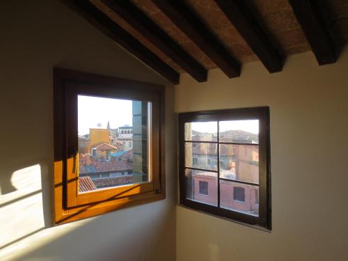 two windows in a room with a view of a city at Appartamenti San Luca in Venice