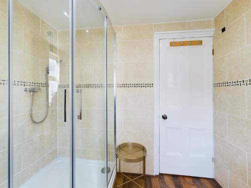 a shower with a glass door in a bathroom at Modern 5 Bedroom House Near Lark Lane in Liverpool