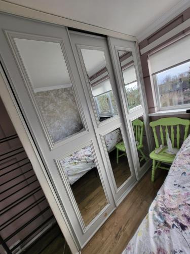 a room with four windows and a bed in a room at Alis haven in Pegswood