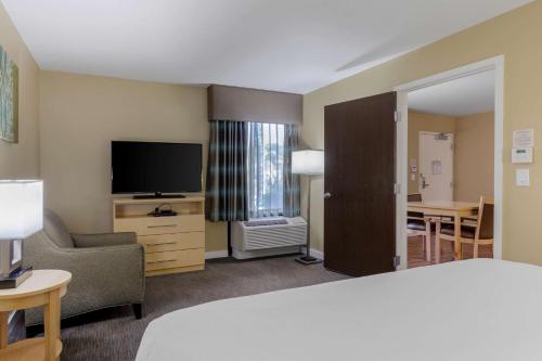 a hotel room with a bed and a flat screen tv at Best Western Plus South Coast Inn in Santa Barbara