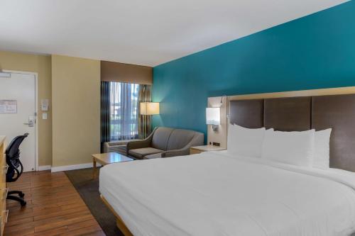 a hotel room with a large bed and a couch at Best Western Plus South Coast Inn in Santa Barbara