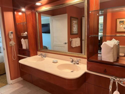 uma casa de banho com um lavatório e um espelho grande em Palm Beach Shores Resort and Vacation Villas em Palm Beach Shores