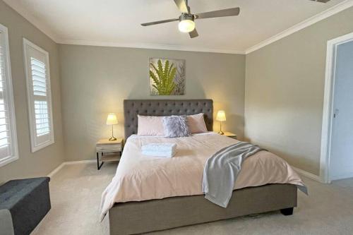 a bedroom with a bed and a ceiling fan at Charming 6 BRM Villa in Melbourne Mullum Mullum Precinct in Doncaster East