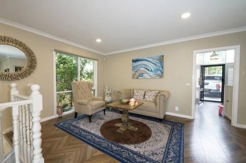 a living room with a couch and a table at Charming 6 BRM Villa in Melbourne Mullum Mullum Precinct in Doncaster East