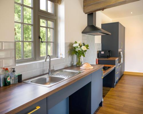 a kitchen with a sink and a counter top at The Stables and The Tackroom at Castle Chase, Ayston 