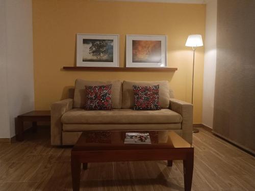 a living room with a couch and a coffee table at Hotel Boutique Confort Suites in Popayan